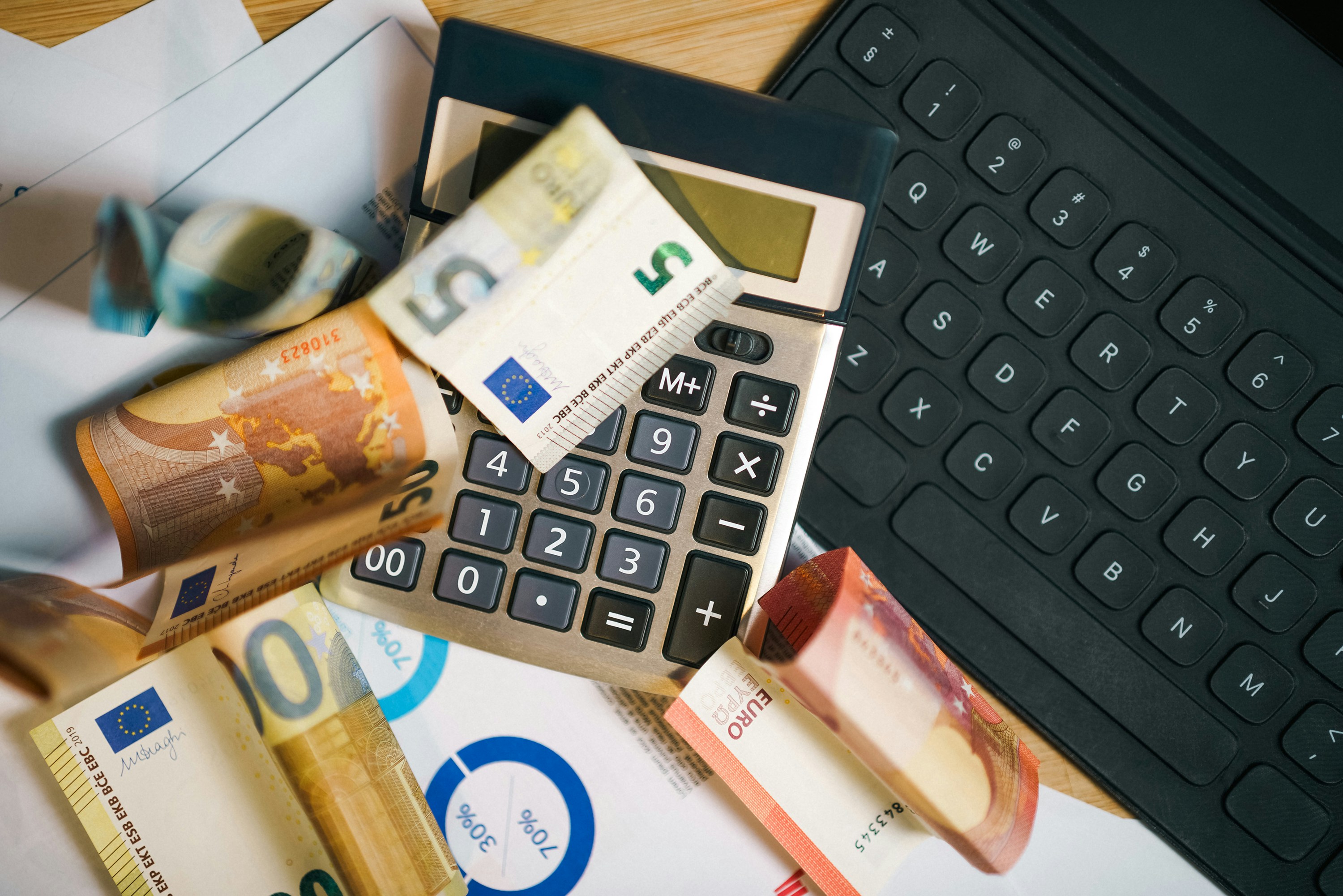 calculator and pile of money - Small Business Tax Planning