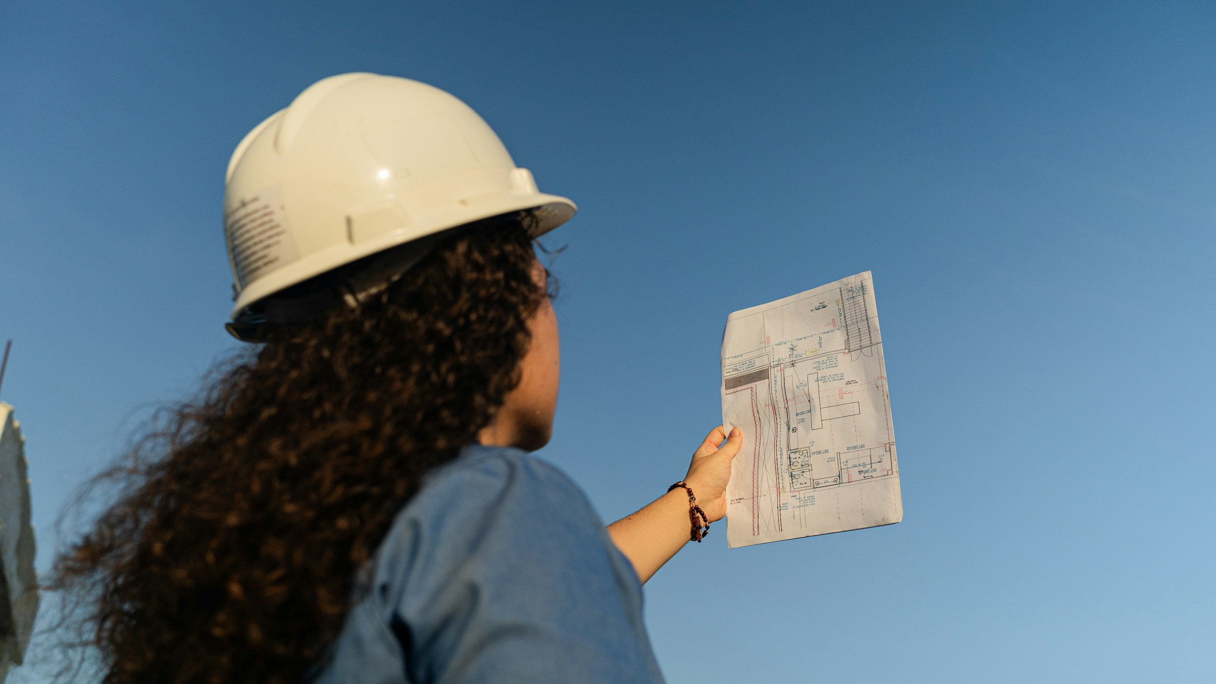 woman looking at plans - R&D Tax Credits for Construction